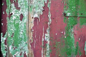 Detailed and colorful close up at cracked and peeling paint on concrete wall textures in high resolution photo