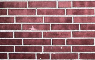 Detailed view at a colorful old and weathered brick wall texture as a panoramic background. photo