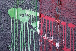 Detailed and colorful close up at cracked and peeling paint on concrete wall textures in high resolution photo