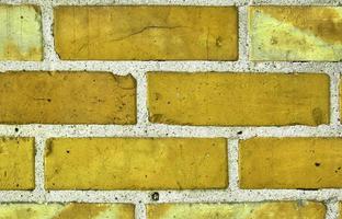 Detailed view at a colorful old and weathered brick wall texture as a panoramic background. photo