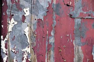 Detailed and colorful close up at cracked and peeling paint on concrete wall textures in high resolution photo