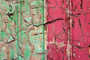 Detailed and colorful close up at cracked and peeling paint on concrete wall textures in high resolution photo