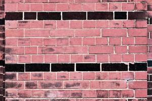 Detailed view at a colorful old and weathered brick wall texture as a panoramic background. photo