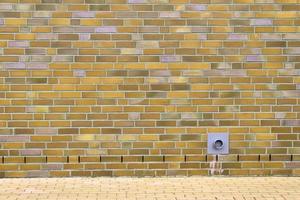 Detailed view at a colorful old and weathered brick wall texture as a panoramic background. photo