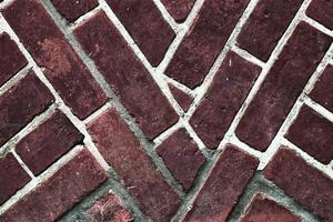 Detailed view at a colorful old and weathered brick wall texture as a panoramic background. photo