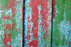 Detailed and colorful close up at cracked and peeling paint on concrete wall textures in high resolution photo