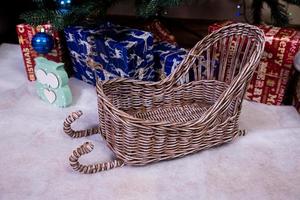 Christmas, New Year interior with red brick wall background, decorated fir tree with garlands and balls, dark drawer photo