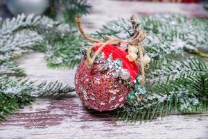 Creative diy craft hobby. Making handmade craft christmas ornaments and balls with felt spruce tree. Woman's leisure, holiday decorations. Closeup of female hands at white wood background photo