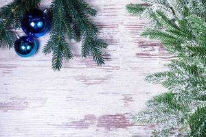 Flat lay composition with serpentine streamers and Christmas decor on wooden background. Space for text Balls, branches, hat, photo