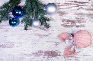 Flat lay composition with serpentine streamers and Christmas decor on wooden background. Space for text Balls, branches, hat, photo