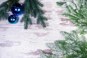 Flat lay composition with serpentine streamers and Christmas decor on wooden background. Space for text Balls, branches, hat, photo