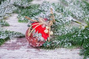 Creative diy craft hobby. Making handmade craft christmas ornaments and balls with felt spruce tree. Woman's leisure, holiday decorations. Closeup of female hands at white wood background photo