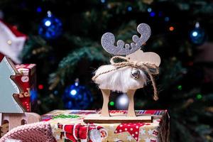 knitted elk. cute moose. toy against the background of a New Year's garland, knitted hare and elk on a Christmas tree photo