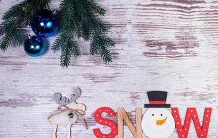 Flat lay composition with serpentine streamers and Christmas decor on wooden background. Space for text Balls, branches, hat, photo