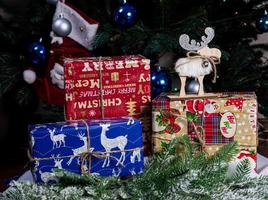 knitted elk. cute moose. toy against the background of a New Year's garland, knitted hare and elk on a Christmas tree photo