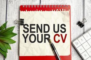 red notebook, send us your cv words and white background photo