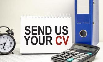 send us your cv words on white sticker with calculator and clock photo