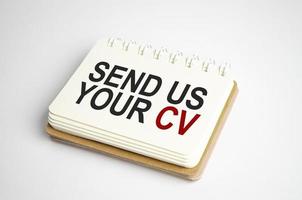 send us your cv Text on business paper on office table photo