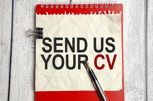 red notebook, send us your cv words and white background photo