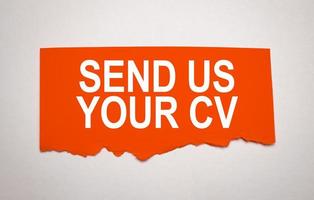 send us your cv on torn red paper on grey background photo