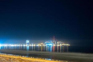 Mazatlan sinaloa beach at night with luminous city in the background photo