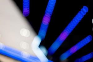 abstract blurred background of lights. Abstract blurry dark indoor plaza hall with a lot of small bokeh photo