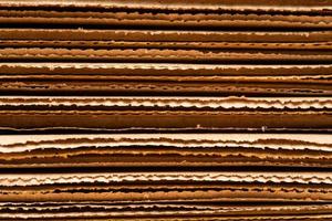 corrugated cardboard for packing. abstract background horizontal lines with wavy lines. Stack of unpacked not assembled cardboard box. photo