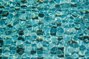 Surface of the swimming pool. Blue water texture for background. photo