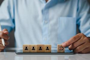 Inbound marketing strategy, customer retention, digital marketing and attracting potential customers in business concept. Wooden cubes with magnet icon attracts the customer icons. Business strategy. photo