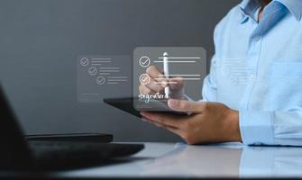 Electronic signature business concept. Manager is electronic sign an agreement on tablet, business approved, executing plan, project approved. digital signature. electronic document, digital business photo