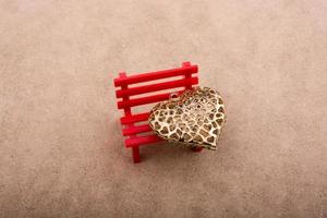 Heart shaped object on red bench