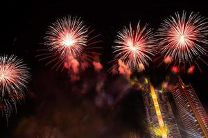 New year celebrate,  crowd and colorful fireworks near the river, Thailand photo