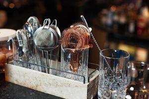 beautiful view composition with different bar equipment and steel tools which stand on bar counter photo