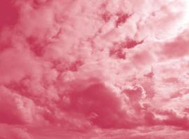 Beautiful fluffy white cloud against the Magenta sky. Sky clouds. Abstract background texture. Copy space. The concept of hope. Color 2023 Viva Magenta photo