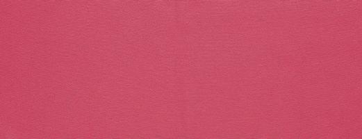 Texture of smooth knitted sweater with pattern. Handmade knitting wool or cotton fabric texture. Background of Large knit pattern with knitting needle or crochet. Color Of The Year 2023 - Viva Magenta photo