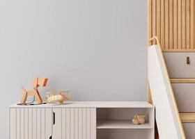 Empty gray wall in modern child room. Mock up interior in contemporary, scandinavian style. Copy space for artwork, picture or poster. Sideboard, toys. Close up view. Cozy room for kids. 3D render. photo