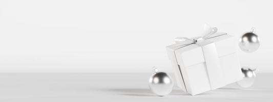 Gift box and silver Christmas decoration on white background with empty space for text. Present. Xmas banner with copy space. Minimalist design. Template for greeting, invitation card. 3D render. photo