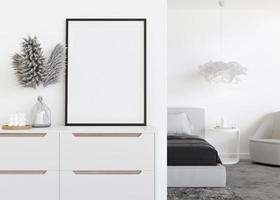 Empty vertical picture frame on white wall in modern bedroom. Mock up interior in contemporary style. Free, copy space for your picture. Bed, sideboard, pampas grass in vase. 3D rendering. photo