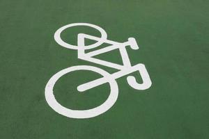 A bicycle symbol on green floor. Bike lane sign. photo