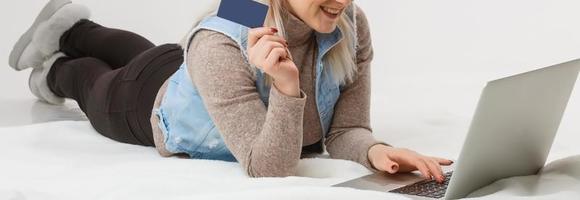 A Happy Woman holding a credit card and shopping from the internet photo