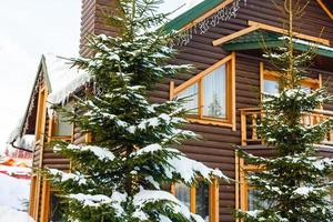 wooden house in winter forest photo