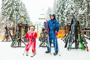 Winter, ski - Little girl with mother in ski resort photo