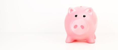 Closeup of a piggy bank against white background. Banner with place for text. Savings,investment,retirement fund concept photo