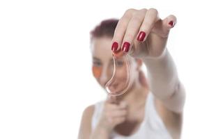 woman with cosmetic patches moisturizing on skin under eyes. photo