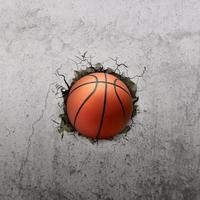 Basketball ball flying through the wall with cracks photo