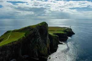 Ocean coast at Neist point lighthouse, Scotland photo