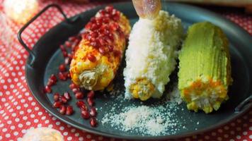 Mexican corn elote in three ways. Pressed with cheese, guacamole and pomegranate. Maxican flag video