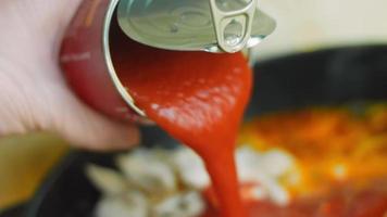 Mix the ingredients for the Mexican soup with a wooden spoon. Macro shooting video