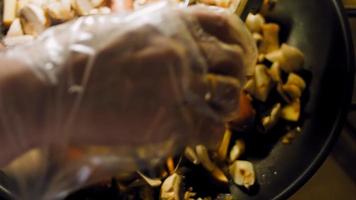 The cook takes the pan from the fire with the sausages that are frying video