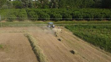 Tractor Machine Working on Hay Bales in Agriculture Field video
